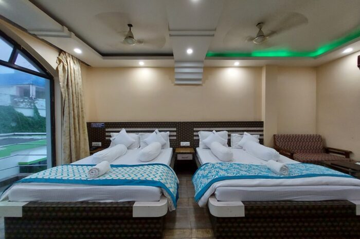 A spacious and luxurious four-bedroom balcony room with a scenic view at Mohana Beach Resort in Mandarmani, West Bengal, featuring comfortable accommodations and a beautiful seaside setting.